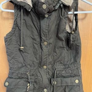 YMI warm, lined vest in olive green. This offers both zip and snap closure.